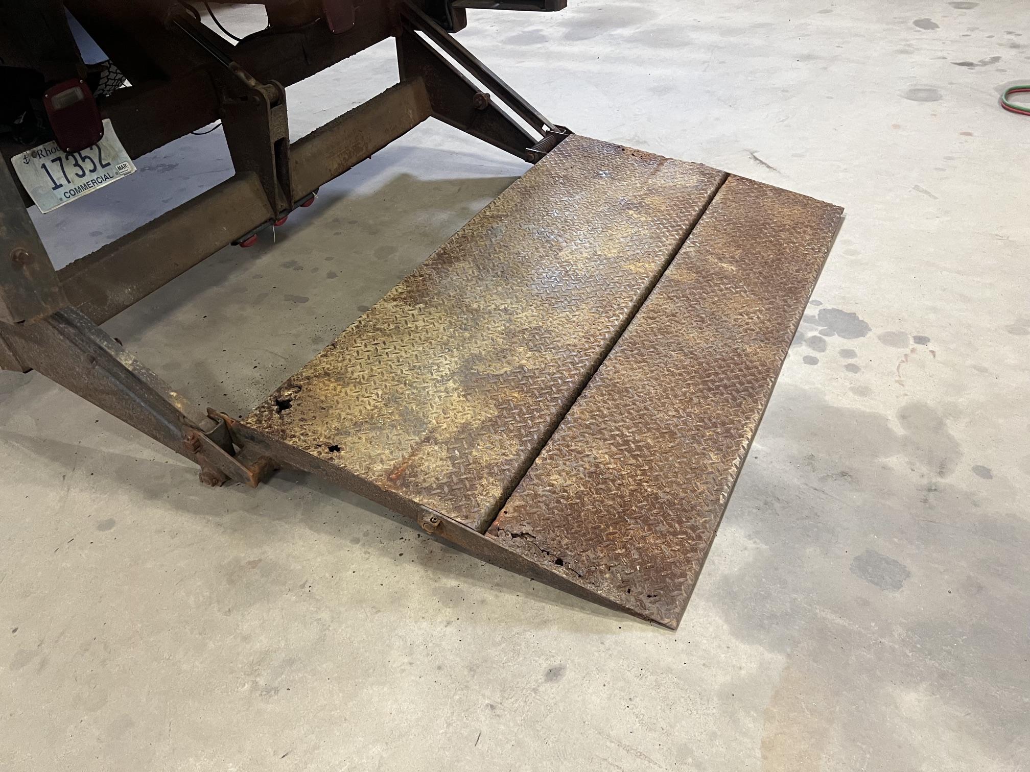 Rusted diamond plate piece on the shop floor mid-fabrication