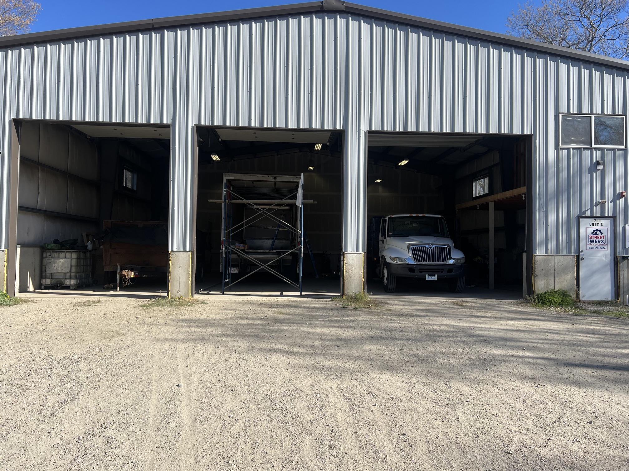 Street Werx shop exterior — three-bay metal building in Tiverton, RI